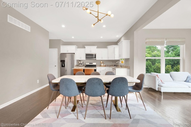 2962 Iowa Dr, Troy, MI 48083 - dining space featuring a chandelier, wood finished floors, and recessed lighting