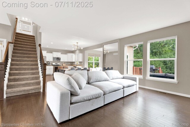 2962 Iowa Dr, Troy, MI 48083 - living room featuring stairs, dark wood-style floors, recessed lighting, and a chandelier