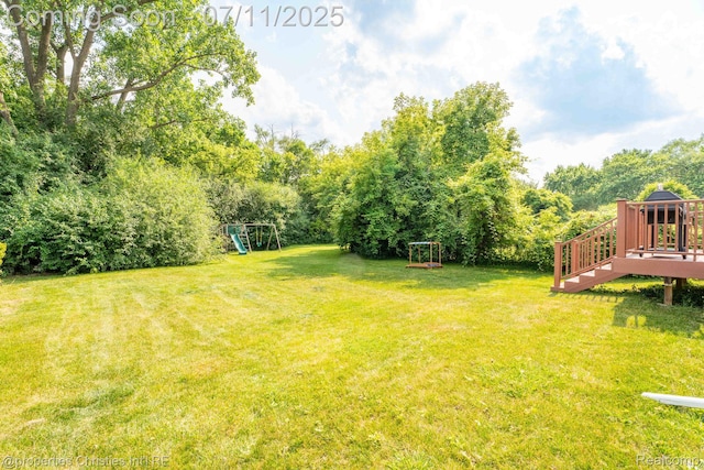 2962 Iowa Dr, Troy, MI 48083 - view of green lawn featuring a playground and a deck