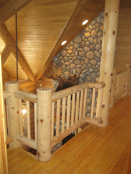 4231 Wildwood Ln, Moran, MI 49760 - stairs with hardwood / wood-style floors, wood ceiling, and log walls