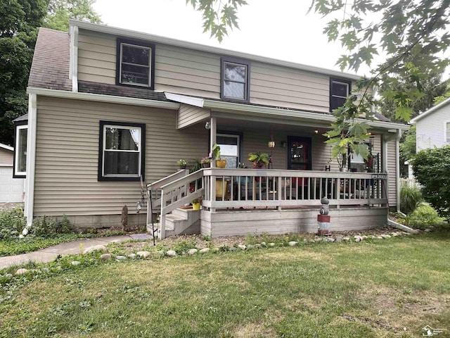 15427 Keegan Rd, Monroe, MI 48161 - view of front of home with a porch, a front lawn, and a garage