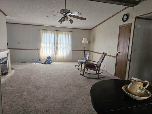 22460 Klines Resort Lot 117, Three Rivers, MI 49093 - sitting room featuring ornamental molding, a ceiling fan, a textured ceiling, carpet flooring, and a glass covered fireplace