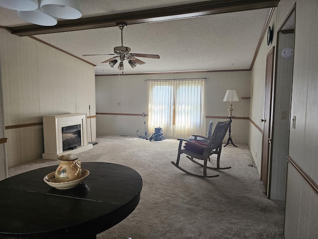 22460 Klines Resort Lot 117, Three Rivers, MI 49093 - living room featuring carpet flooring, ornamental molding, a textured ceiling, a ceiling fan, and a fireplace with raised hearth