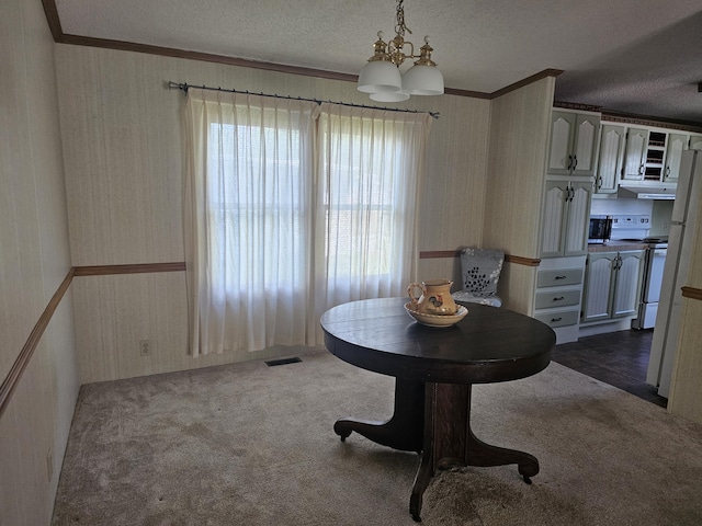 22460 Klines Resort Lot 117, Three Rivers, MI 49093 - dining area with wallpapered walls, a chandelier, ornamental molding, a textured ceiling, and dark carpet
