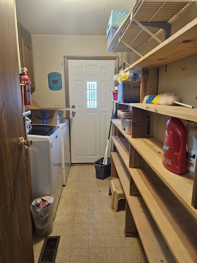 22460 Klines Resort Lot 117, Three Rivers, MI 49093 - laundry room featuring washing machine and dryer, tile patterned floors, and a textured ceiling