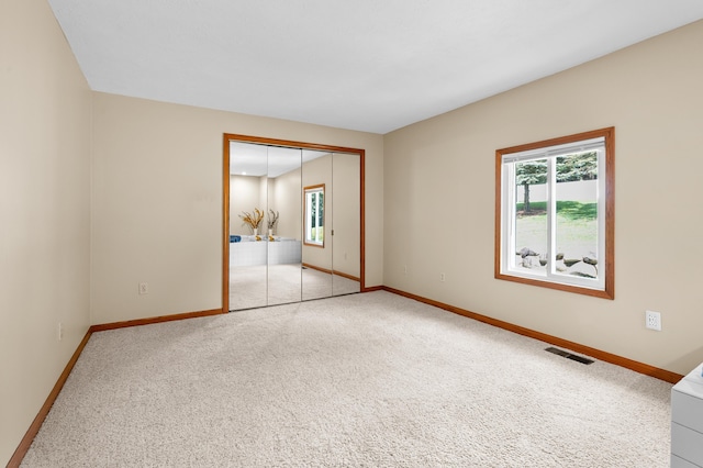 22100 N Uldriks Dr, Battle Creek, MI 49017 - unfurnished bedroom featuring multiple windows, carpet floors, and a closet