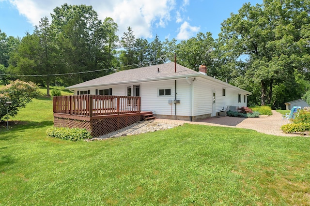 22100 N Uldriks Dr, Battle Creek, MI 49017 - back of house featuring a wooden deck, a chimney, and a yard