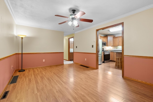 22100 N Uldriks Dr, Battle Creek, MI 49017 - unfurnished living room featuring light wood-style flooring, ceiling fan, and ornamental molding