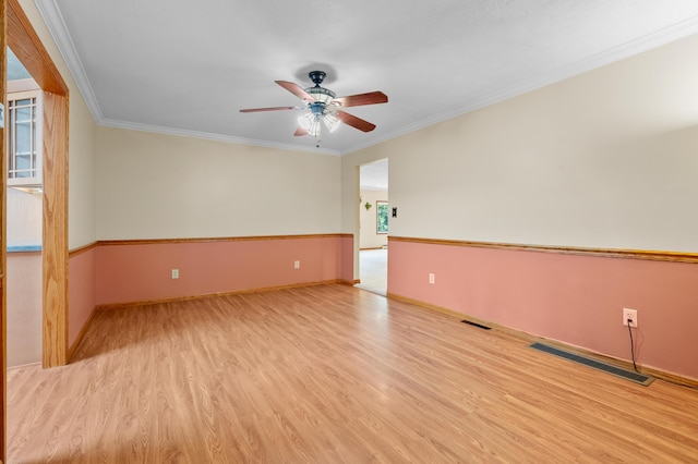 22100 N Uldriks Dr, Battle Creek, MI 49017 - empty room with ceiling fan, wood finished floors, and crown molding