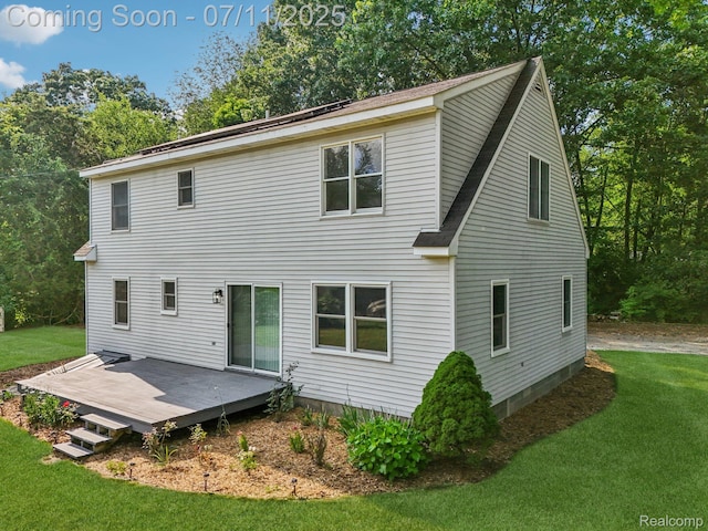 10746 Winthrop, Pinckney, MI 48169 - rear view of house with a lawn, a deck, roof with shingles, and view of wooded area