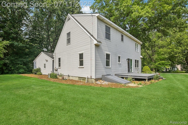 10746 Winthrop, Pinckney, MI 48169 - view of property exterior featuring a yard, a wooden deck, and view of wooded area