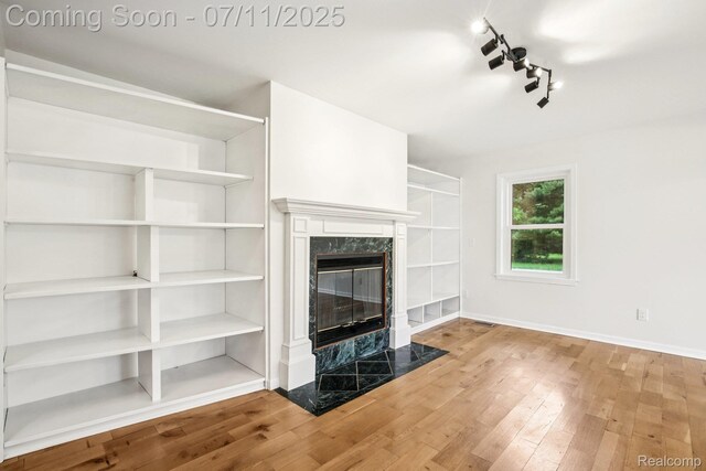 10746 Winthrop, Pinckney, MI 48169 - unfurnished living room with a fireplace and wood finished floors