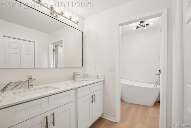 10746 Winthrop, Pinckney, MI 48169 - full bathroom featuring wood finished floors, double vanity, and a freestanding bath