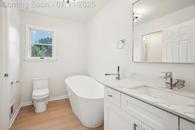 10746 Winthrop, Pinckney, MI 48169 - bathroom with a freestanding tub, vanity, and wood finished floors