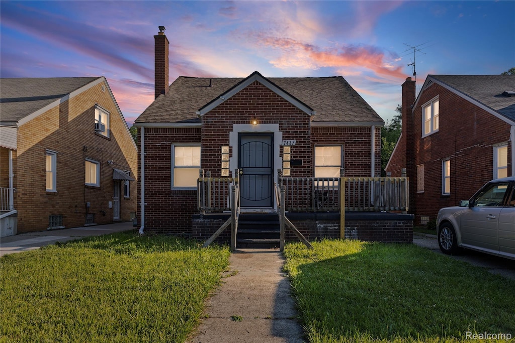 7437 E Robinwood St, Detroit, MI 48234 - bungalow-style house with brick siding, a chimney, and a yard