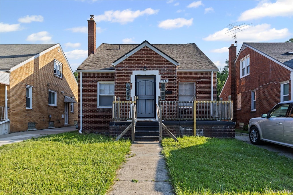 7437 E Robinwood St, Detroit, MI 48234 - bungalow-style house featuring a chimney, brick siding, a front lawn, and roof with shingles