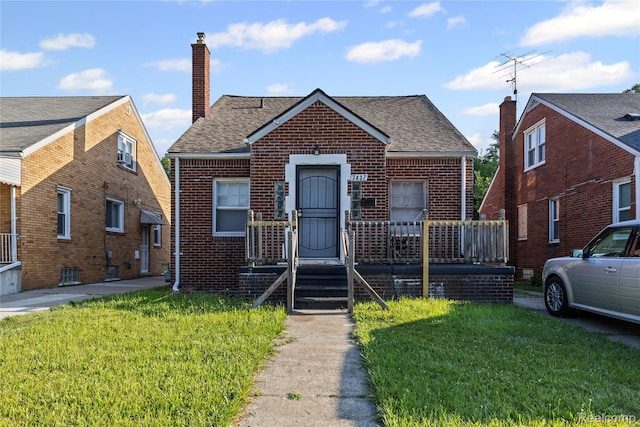7437 E Robinwood St, Detroit, MI 48234 - bungalow-style house featuring a chimney, brick siding, a front lawn, and roof with shingles