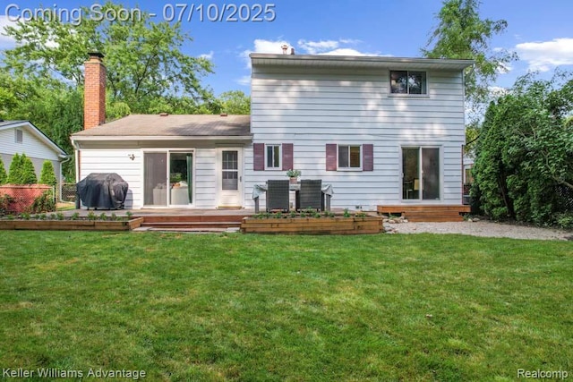 9157 Hackberry Ave, Plymouth, MI 48170 - back of property featuring a lawn, a wooden deck, and a chimney
