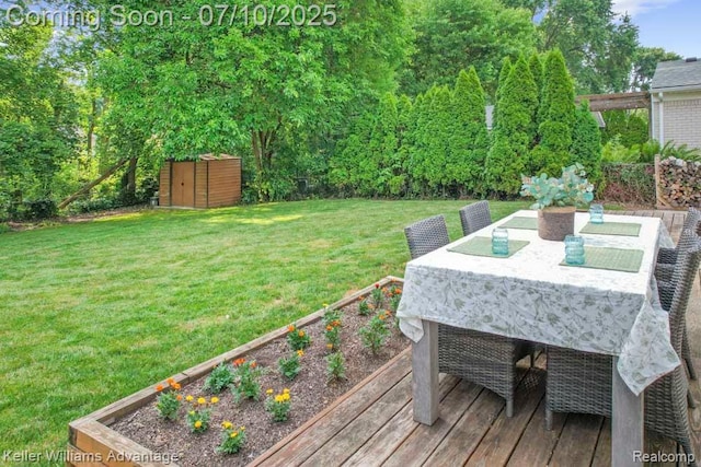 9157 Hackberry Ave, Plymouth, MI 48170 - view of green lawn featuring a shed, outdoor dining area, a vegetable garden, and a wooden deck