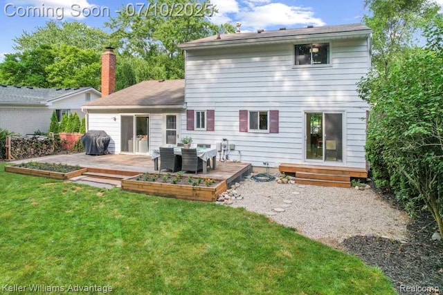 9157 Hackberry Ave, Plymouth, MI 48170 - rear view of house featuring a deck, a lawn, and a chimney