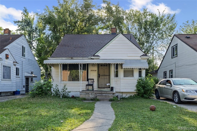 18936 Gilchrist St, Detroit, MI 48235 - bungalow-style home with a front lawn, a chimney, and roof with shingles