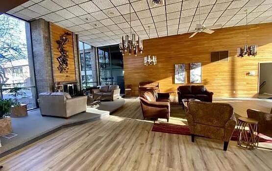 18220 University Park Dr, Livonia, MI 48152 - community lobby with a wall of windows and wooden walls