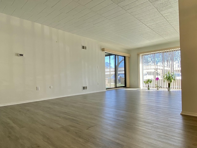 18220 University Park Dr, Livonia, MI 48152 - spare room featuring dark wood-style floors and baseboards