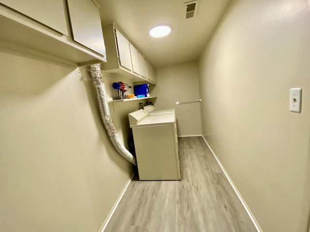 18220 University Park Dr, Livonia, MI 48152 - washroom featuring cabinet space, washing machine and clothes dryer, and light wood-type flooring