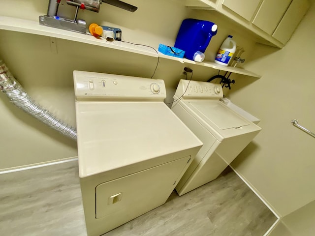 18220 University Park Dr, Livonia, MI 48152 - laundry area featuring wood finished floors and separate washer and dryer