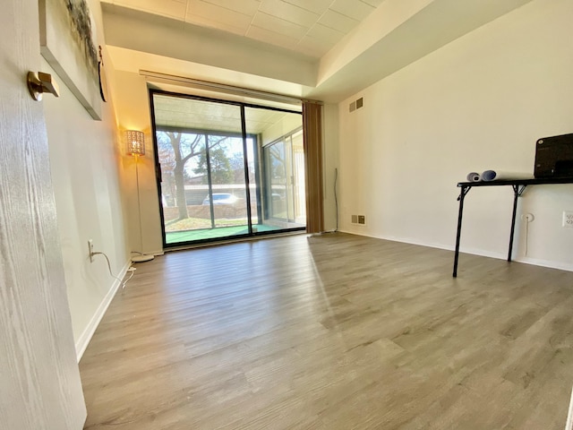 18220 University Park Dr, Livonia, MI 48152 - unfurnished room featuring wood finished floors and floor to ceiling windows
