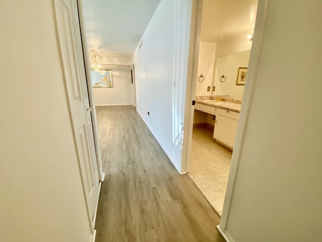 18220 University Park Dr, Livonia, MI 48152 - corridor with light wood-type flooring and a sink