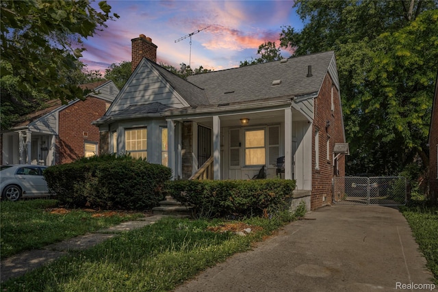11601 Nottingham Rd, Detroit, MI 48224 - bungalow-style house featuring a chimney, a shingled roof, brick siding, and concrete driveway