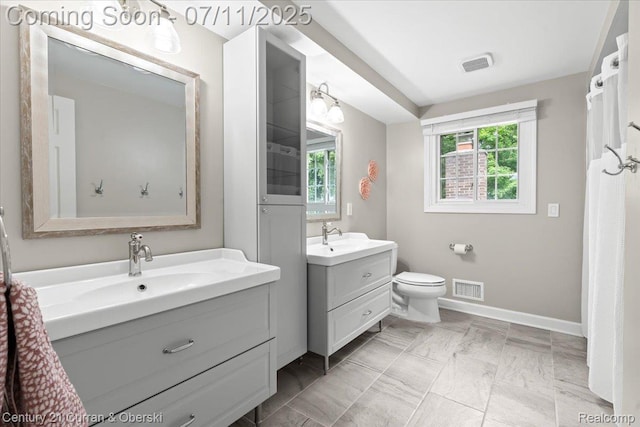 42369 Crestview Cir, Northville, MI 48168 - full bathroom featuring two vanities and baseboards