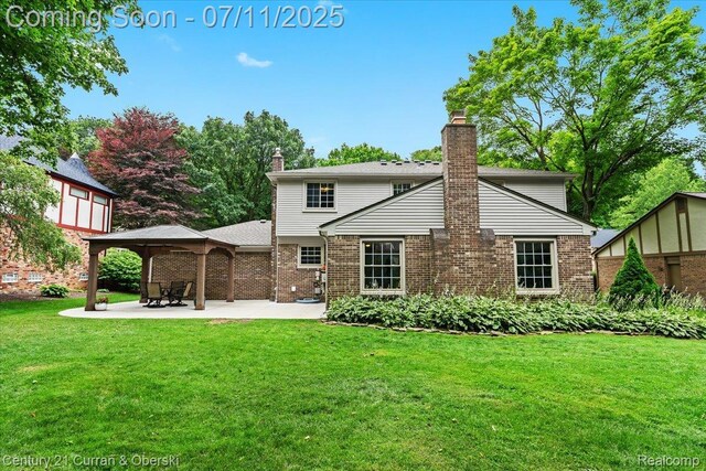 42369 Crestview Cir, Northville, MI 48168 - back of house featuring a chimney, brick siding, a gazebo, and a yard
