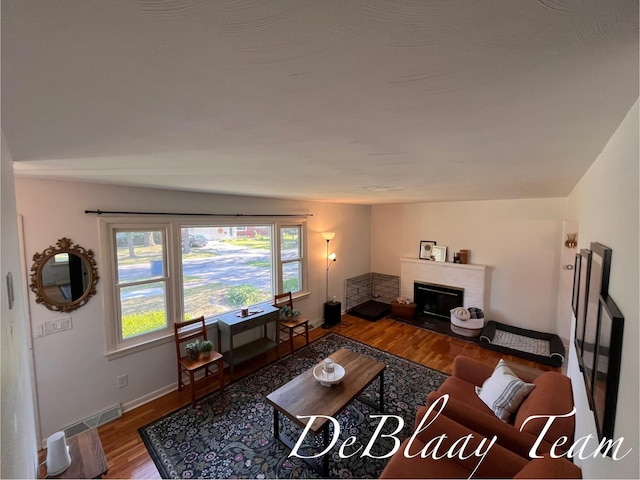 1056 Sherwood Rd, Muskegon, MI 49441 - living area featuring wood finished floors and a brick fireplace