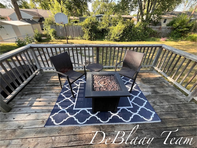 1056 Sherwood Rd, Muskegon, MI 49441 - wooden deck featuring a fire pit