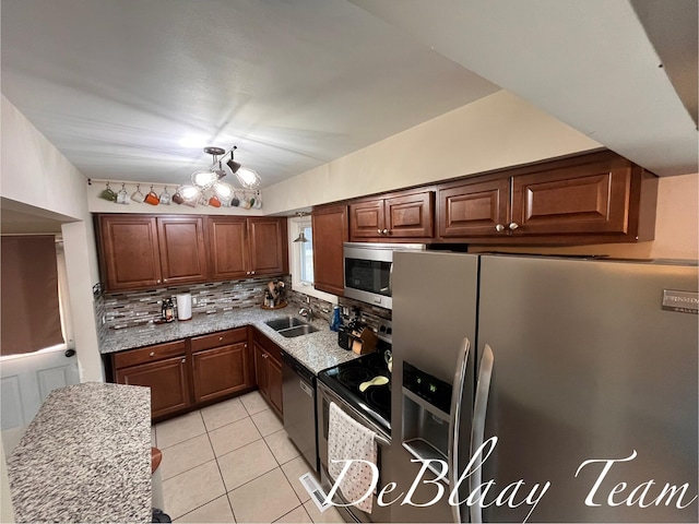 1056 Sherwood Rd, Muskegon, MI 49441 - kitchen with stainless steel appliances, backsplash, light tile patterned floors, and light stone counters
