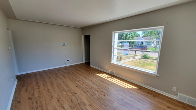 2031 Baker St, Muskegon, MI 49444 - unfurnished room with wood finished floors and baseboards
