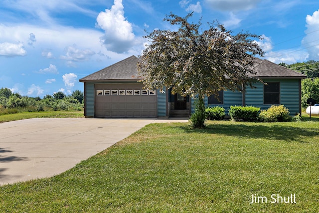 8201 Crocker Rd, Holton, MI 49425 - view of front of house featuring roof with shingles, an attached garage, driveway, and a front yard