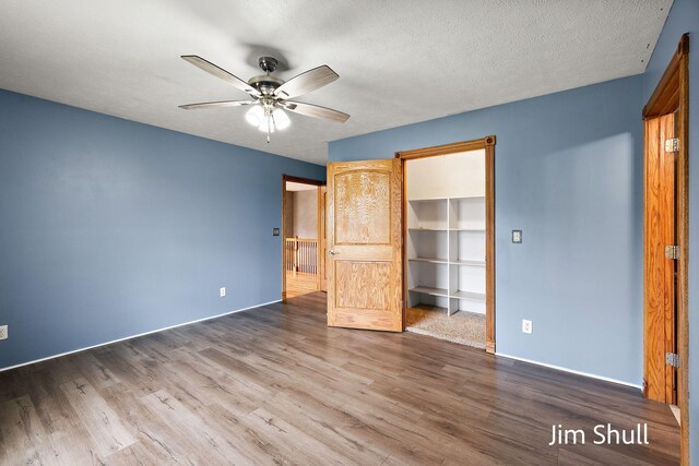 8201 Crocker Rd, Holton, MI 49425 - unfurnished bedroom featuring wood finished floors, a ceiling fan, and a closet