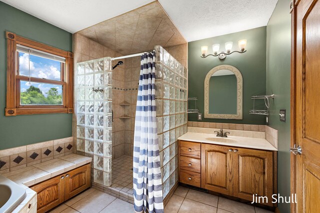 8201 Crocker Rd, Holton, MI 49425 - full bathroom featuring tiled shower, vanity, tile patterned flooring, and a tub