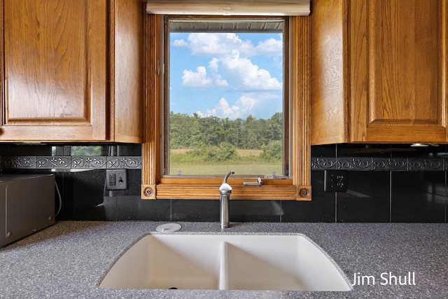 8201 Crocker Rd, Holton, MI 49425 - kitchen featuring decorative backsplash and dark countertops