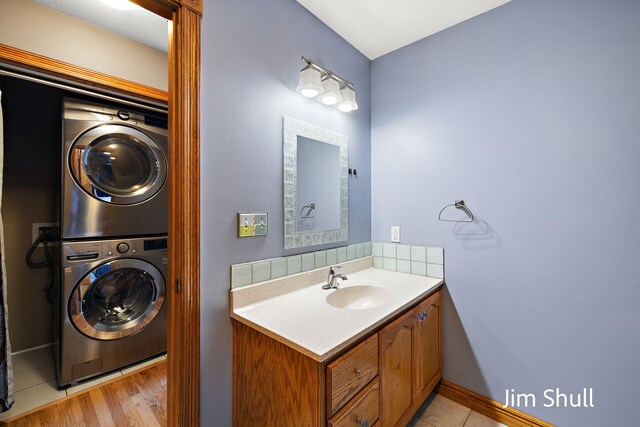 8201 Crocker Rd, Holton, MI 49425 - bathroom featuring stacked washer / dryer and vanity