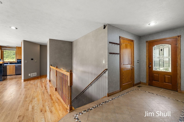 8201 Crocker Rd, Holton, MI 49425 - entryway featuring recessed lighting and light tile patterned floors