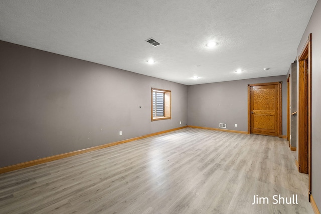 8201 Crocker Rd, Holton, MI 49425 - unfurnished room featuring light wood finished floors, recessed lighting, and a textured ceiling