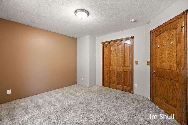 8201 Crocker Rd, Holton, MI 49425 - unfurnished bedroom with carpet, a textured ceiling, and a closet