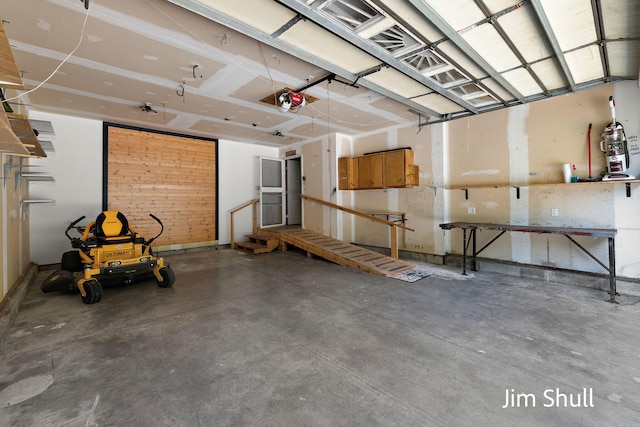 8201 Crocker Rd, Holton, MI 49425 - garage with a garage door opener and a workshop area