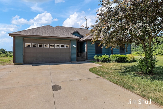 8201 Crocker Rd, Holton, MI 49425 - view of front facade featuring a front lawn, roof with shingles, a garage, and concrete driveway