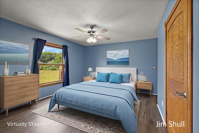 8201 Crocker Rd, Holton, MI 49425 - bedroom featuring dark wood finished floors and a ceiling fan