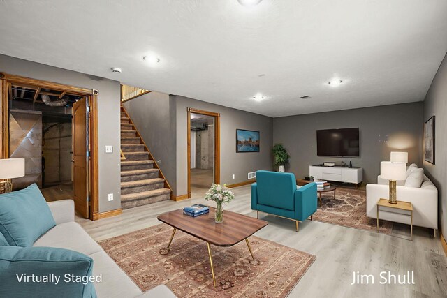 8201 Crocker Rd, Holton, MI 49425 - living area featuring wood finished floors, stairs, and recessed lighting